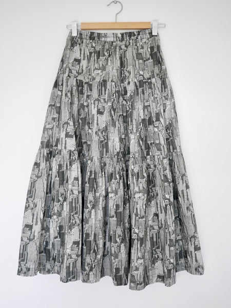 Photo of  3 tiered cotton black and white printed skirt, mid calf length, elastic waisted with voluminous hem from straight on on hanger