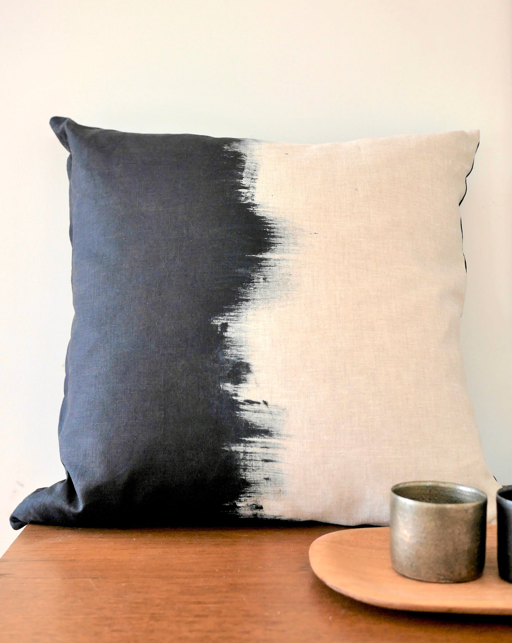 darkest navy hand painted cushion in natural linen background