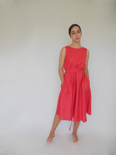 woman wearing below knee length a-line dress in strawberry linen